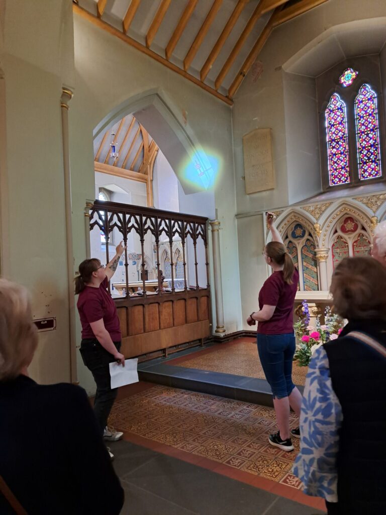 Visitors to Nottingham cathedral being shown details of decorative work by Augustus Pugin