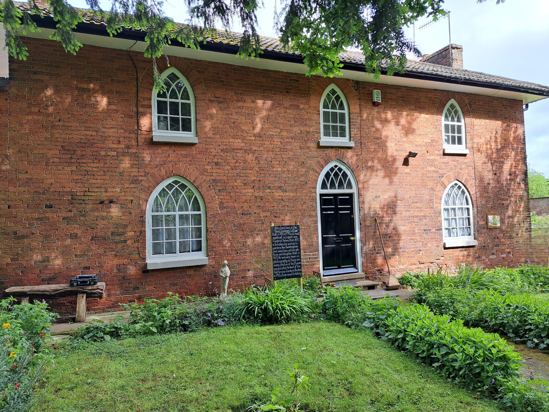Historic gardener's cottage with gothic-style windows. Wollaton Park walled garden