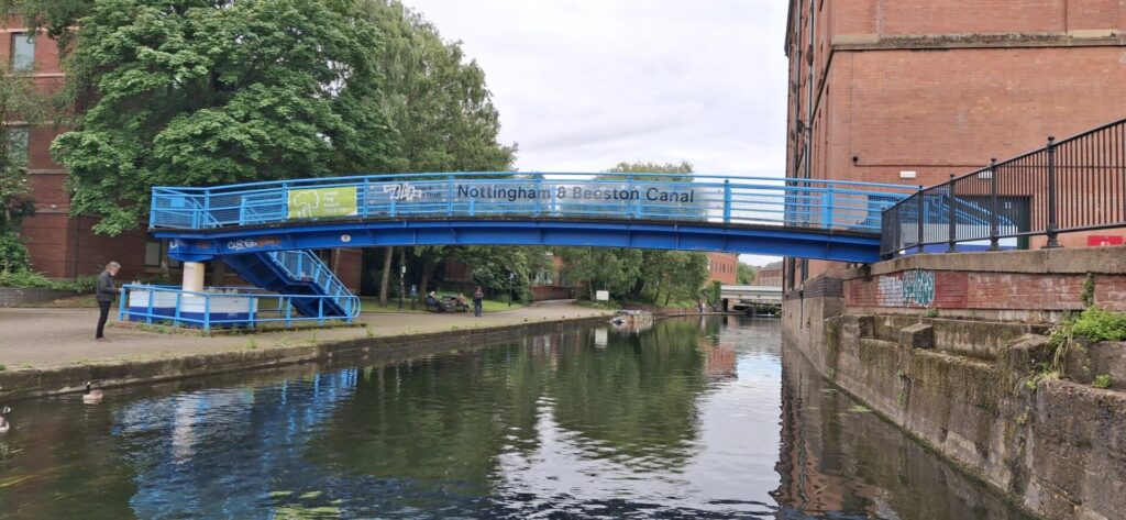 A blue pedestrian bridge over the Nottingham canal